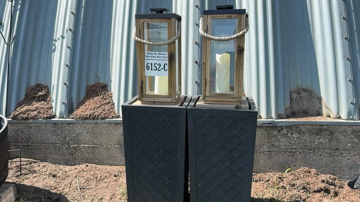 2 - LG WOOD & METAL OUTDOOR LANTERNS ON BLACK PEDESTALS/PLANTERS - DISPERSAL FOR CLARENCE YOUNG - SOLD OFFSITE EDBERG, AB