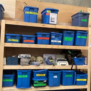 5 SHELVES OF RUBBERMAID BINS FILLED WITH ASSORTED ITEMS -  PURSES, DOLLS, LANTERNS, CAMPINGL