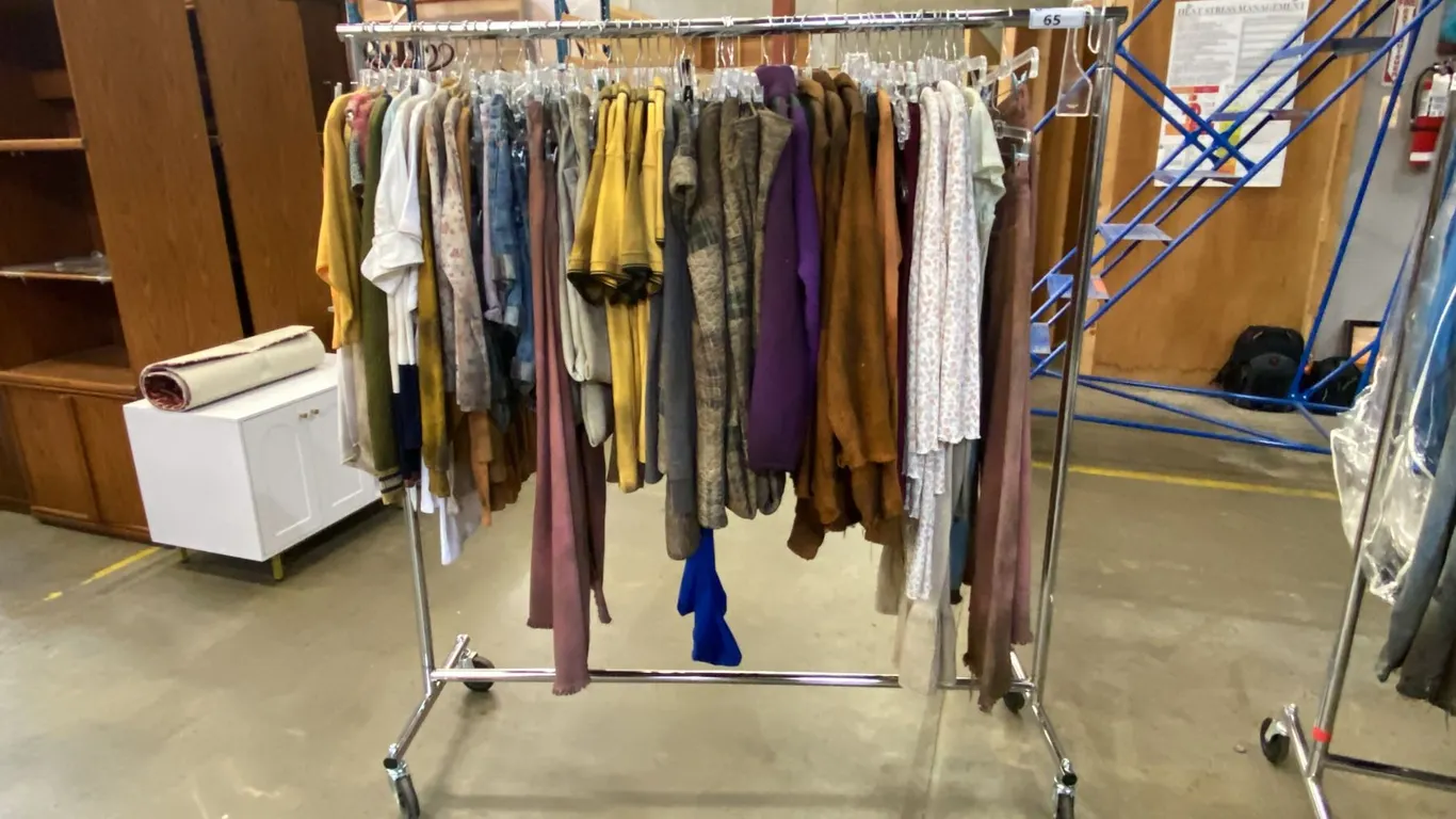 MOBILE WARDROBE RACK FILLED WITH ASSORTED CLOTHING