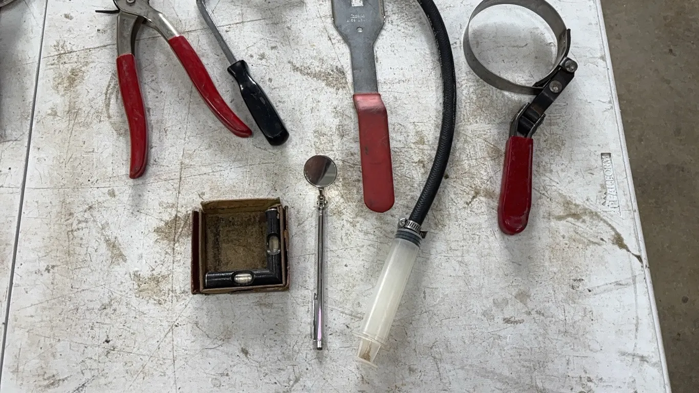 Pliers, oil filter wrench, and level