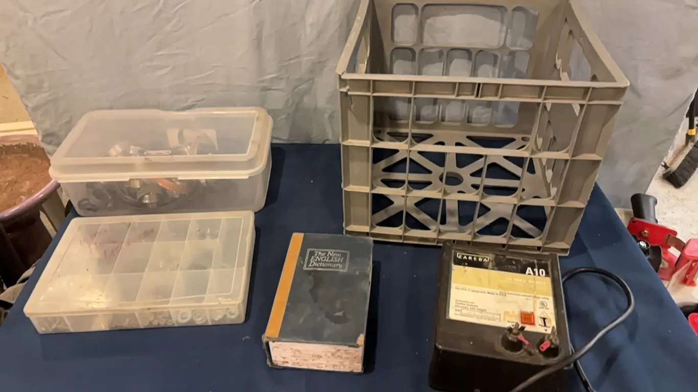 Secret box, electric fence controller, nuts and bolts, and clamps