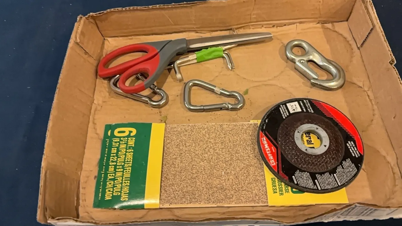 Sand paper, carabiners, and scissors