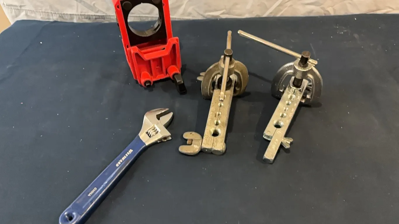 Wrench, flaring tool, and auto-centering drill guide