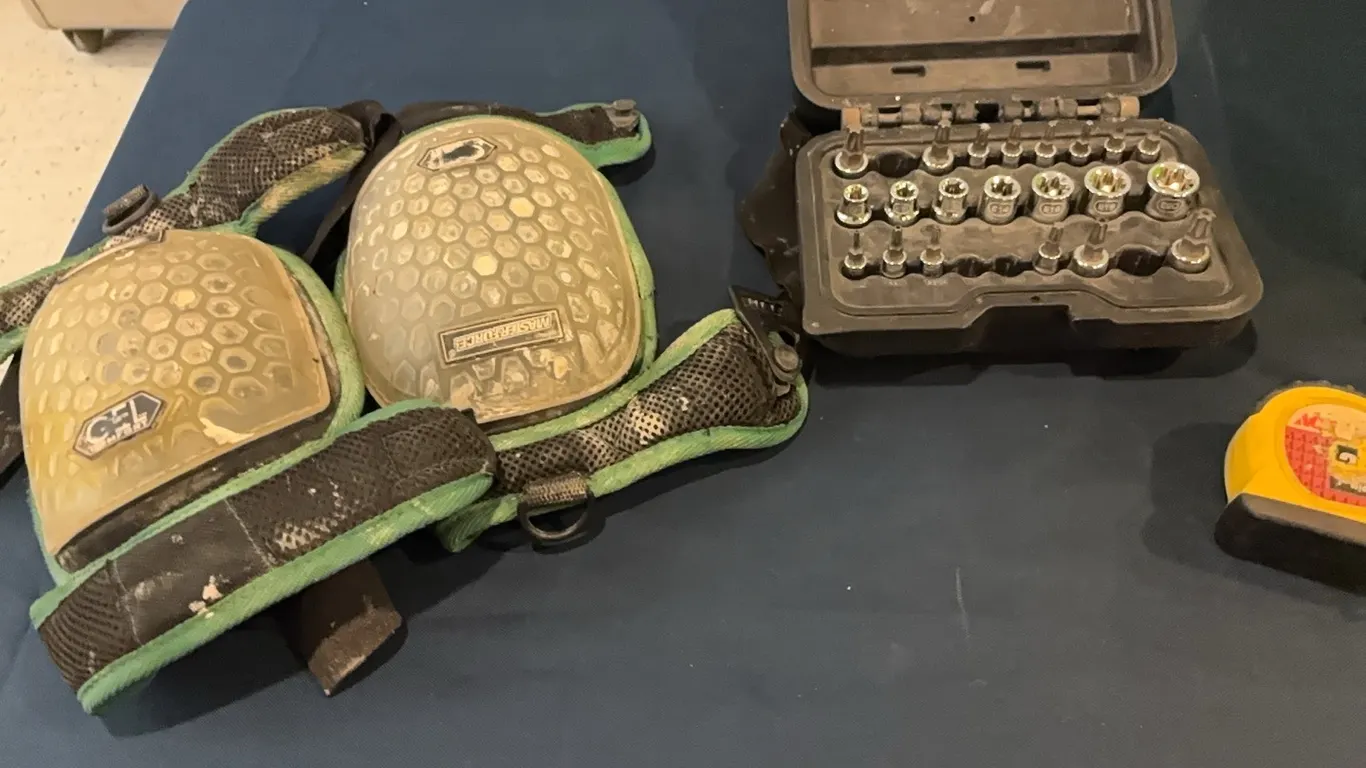 knee pads, tape measure, hex bits, and jumper cables