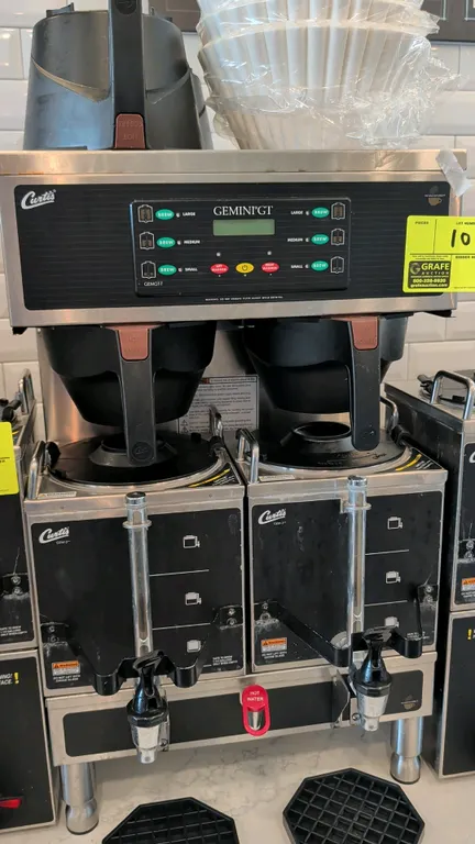 Curtis GEMGT-T Gemini GT twin head commercial coffee brewer. Features digital control panel and central hot water faucet. Includes (2) Curtis GEM-3 sa
