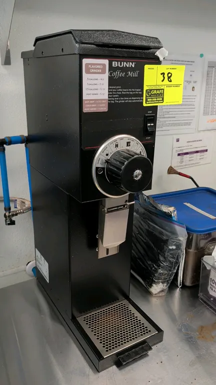 Bunn Coffee Mill commercial coffee grinder. Features multi-position adjustable grind selector dial from coarse to Turkish, dispensing chute with clean