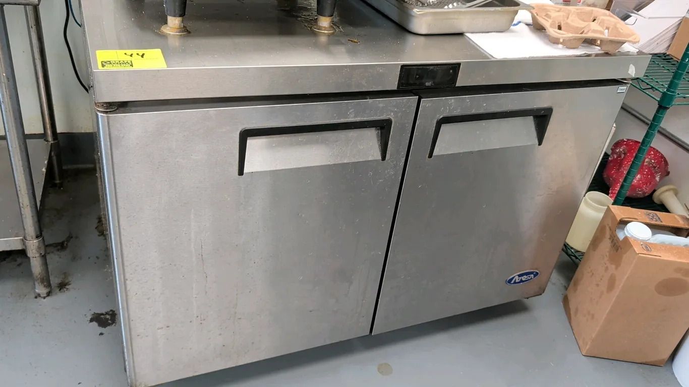 2022 Atosa MGF8406GR 2-door undercounter freezer. Features stainless steel construction, recessed door handles, and interior wire shelving. S/N: MGF84