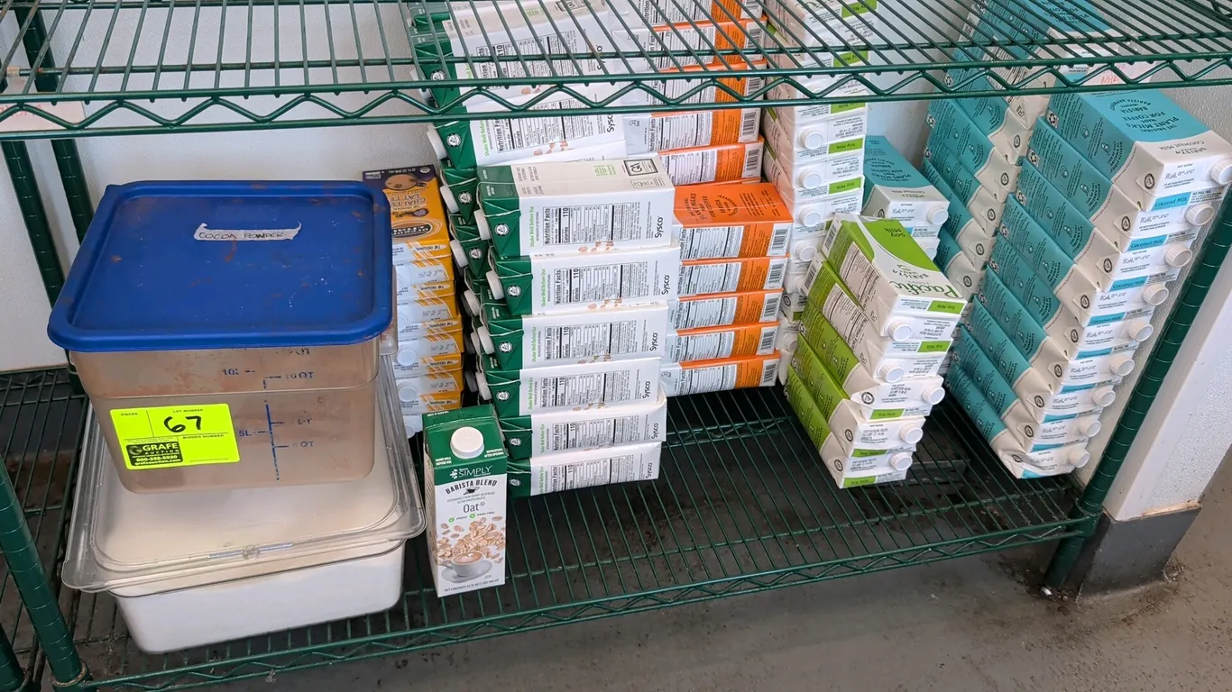 Assorted food storage containers and shelf-stable beverage cartons. Includes clear plastic food storage containers with lids and an assortment of bari