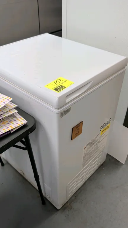 Hotpoint chest freezer. Features a top-opening lid with recessed handle, aluminum interior lining, and (1) upper wire storage basket. Finished in whit