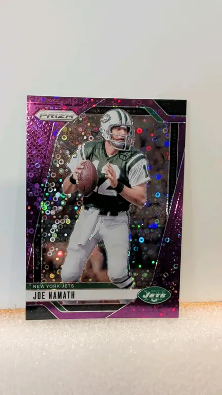 A 2024 Panini Prizm Joe Namath Purple Pulsar Trading Card. (Panini, 2024) Card No. 228 featuring New York Jets Hall of Fame quarterback Joe Namath. Th
