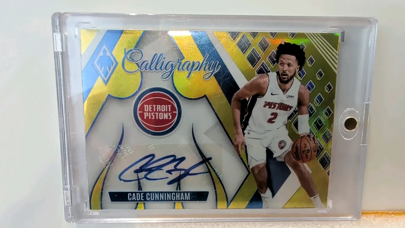 A 2023-24 Panini Phoenix Basketball Cade Cunningham Calligraphy Autograph Card. (Panini, 2023-24) Card No. CG-CCH featuring Detroit Pistons guard Cade
