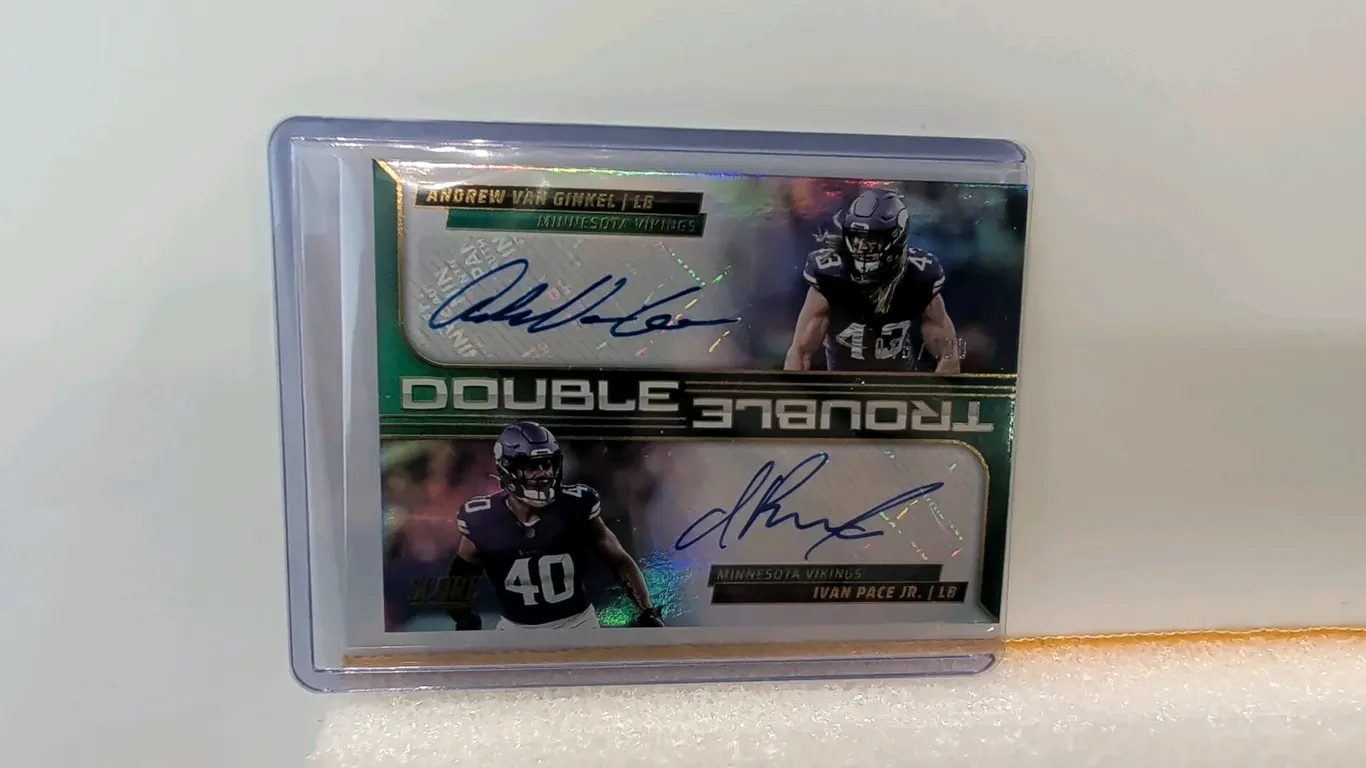 A 2025 Panini Score "Double Trouble" Dual Autograph Card. (Panini, 2025) A Panini Score Football "Double Trouble" trading card signed in blue ink by M