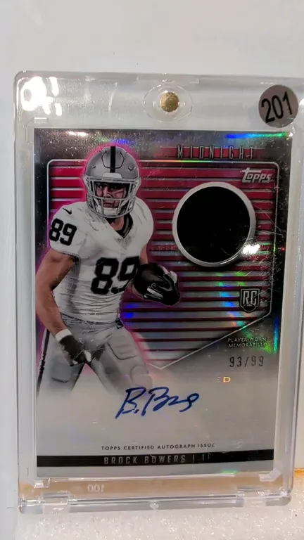 A Brock Bowers Rookie Jersey Autograph Card. (Topps, 2024) A 2024 Topps Midnight Football card #RJA-BB featuring Las Vegas Raiders tight end Brock Bow