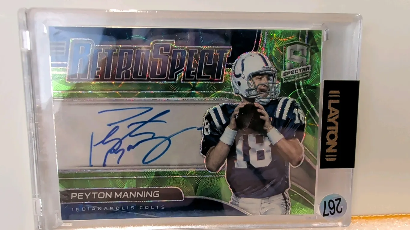 A Peyton Manning Signed 2021 Panini Spectra "Retrospect" Prizm Card. (Panini, 2021) Featuring a blue ink autograph of the Hall of Fame quarterback in