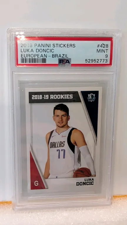 A 2018 Panini Stickers #428 Luka Doncic Rookie Sticker. (Panini, 2018) A European - Brazil edition rookie sticker featuring Luka Doncic with the Dalla