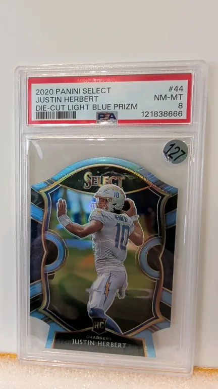 A 2020 Panini Select Justin Herbert Die-Cut Light Blue Prizm Rookie Card. (Panini, 2020) A Panini Select Concourse level rookie football card #44 feat