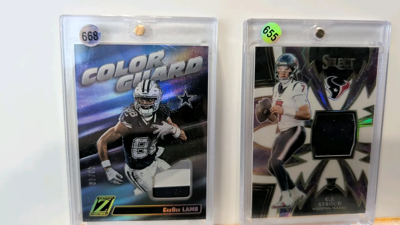 A Pair of Panini NFL Memorabilia Cards. (Panini, 2023-2024) A collection of (2) serial-numbered NFL trading cards with jersey relics. Includes a 2024