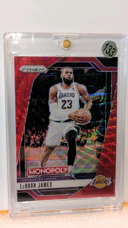 A LeBron James Panini Prizm Monopoly Trading Card. (Panini, 2024-25) An NBA trading card featuring LeBron James of the Los Angeles Lakers in a red spa