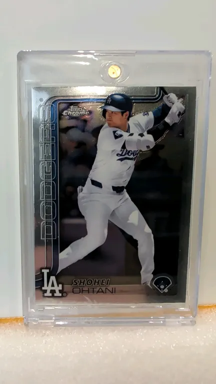 A 2025 Topps Chrome Shohei Ohtani Baseball Card. (Topps, 2025) Card #1 featuring Shohei Ohtani in a Los Angeles Dodgers uniform with a chrome finish.