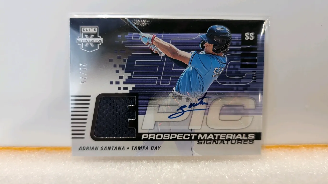 An Adrian Santana Epic Prospect Materials Signatures Baseball Card. (Panini, 2023) From Elite Extra Edition Baseball, featuring a hand-signed autograp