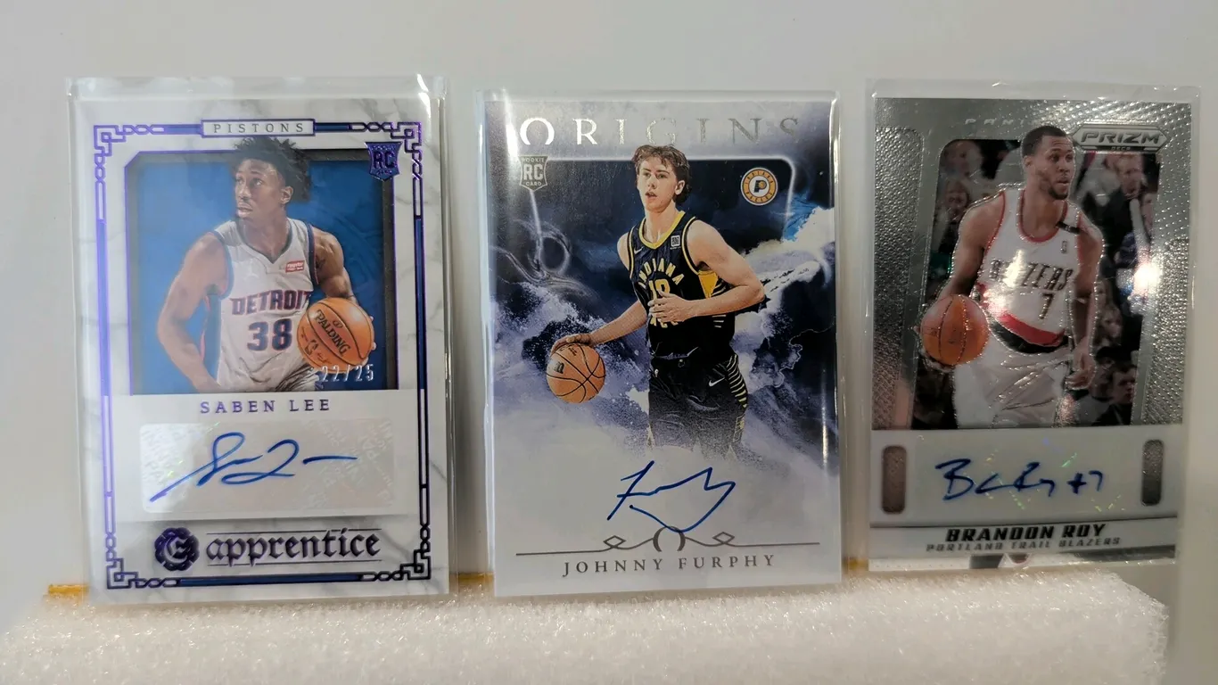 A Collection of Panini Autographed Basketball Cards. (Panini, 2020-2025) A collection of (3) cards featuring authenticated signatures: 2020-21 Chronic