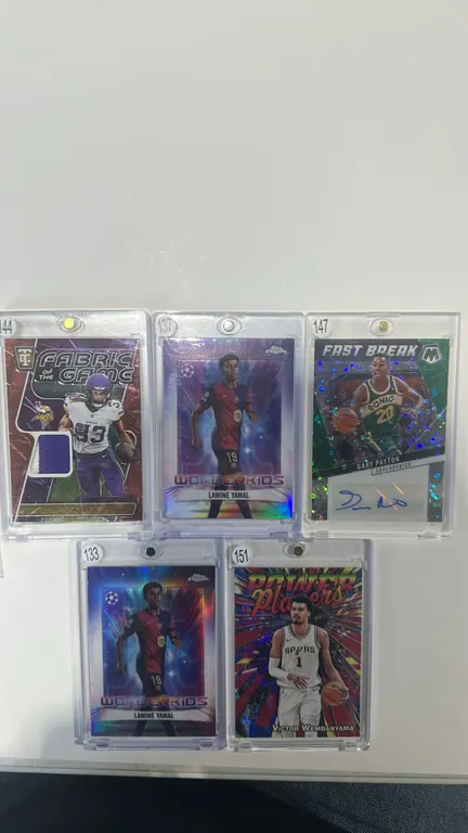 A Collection of Assorted Sports Trading Cards. (Panini/Topps, 2024-2025) Includes a Panini Totally Certified Aaron Jones jersey relic (36/99), Panini