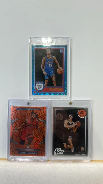 A Collection of (3) Basketball Rookie Cards. (Panini/Topps, 2022-2025) Includes 2022-23 Panini NBA Hoops Ousmane Dieng Blue Ice parallel No. 241, 2024