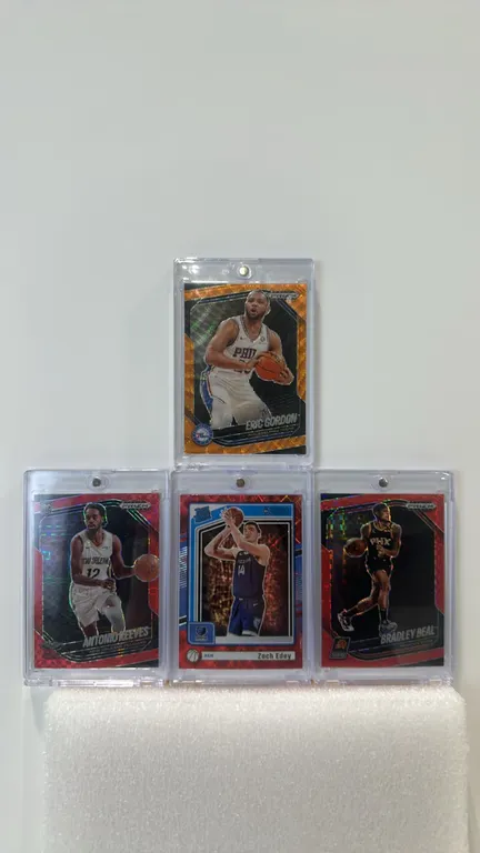 A Collection of 2024-25 Panini Basketball Cards. (Panini, 2024-2025) A lot of (4) cards in magnetic one-touch cases, including Zach Edey Donruss Rated