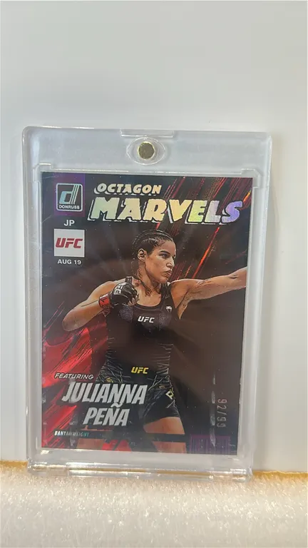 A 2023 Panini Donruss UFC "Octagon Marvels" Julianna Peña Trading Card. (Panini, 2023) Featuring UFC fighter Julianna Peña in the holographic "Octagon