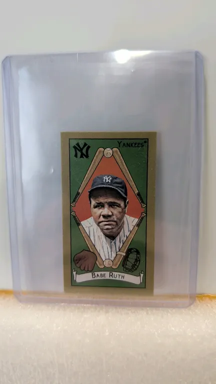 A Babe Ruth Topps Baseball Mini Card. (Topps, 2025) A mini baseball card featuring New York Yankees legend Babe Ruth. The front displays a color portr