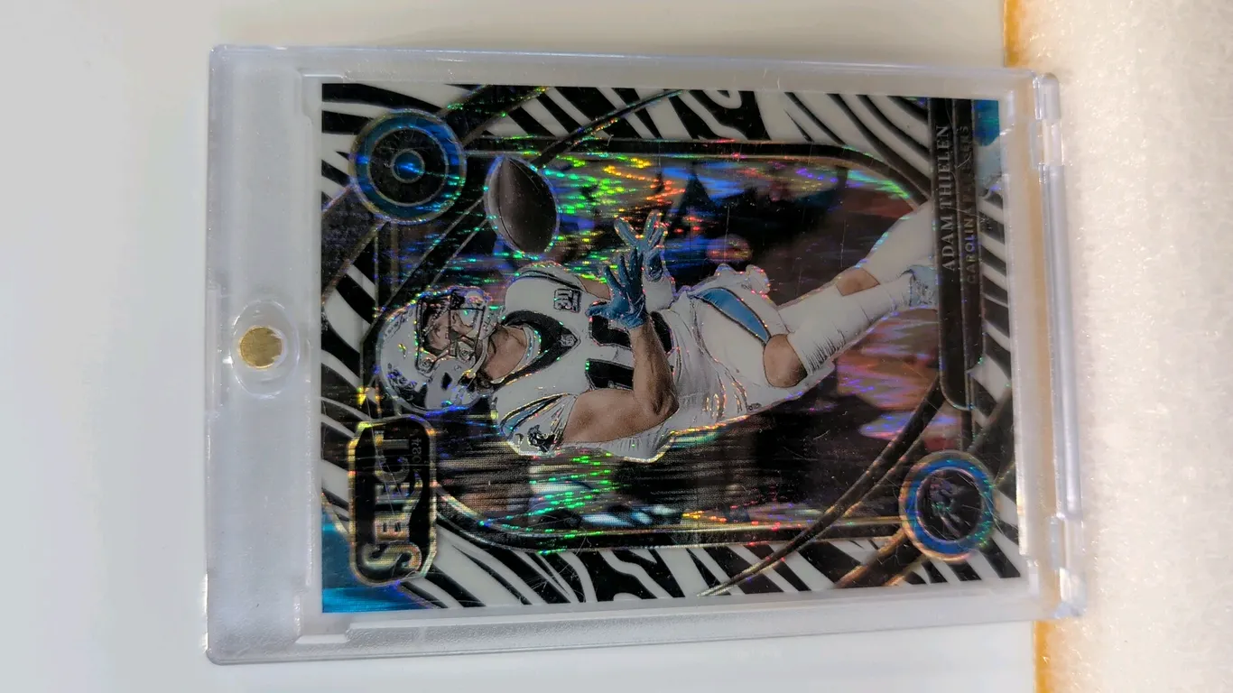 An Adam Thielen Panini Select Zebra Prizm Trading Card. (Panini, 2024) A 2024 Panini Select Football Club Level Zebra Prizm parallel card, No. 202, fe