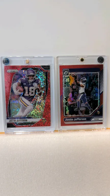 A Pair of Justin Jefferson Football Cards. (Panini, 2024) A pair of Minnesota Vikings trading cards, including a Panini Prizm Red Sparkle card #187 an