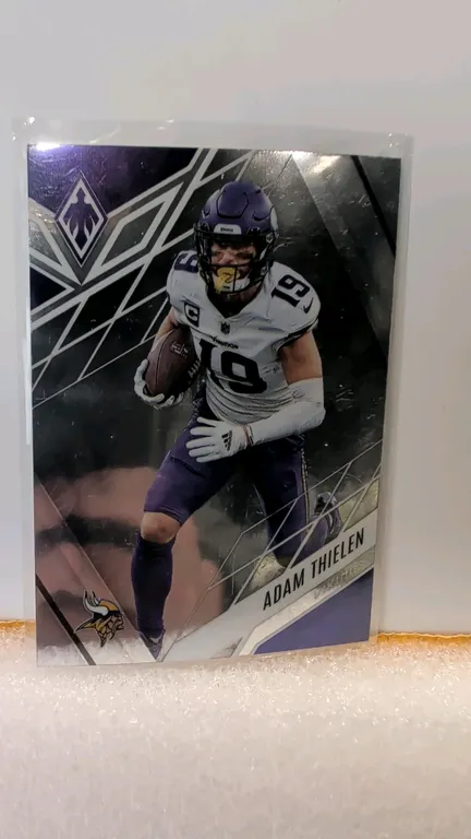 An Adam Thielen 2022 Panini Phoenix Football Trading Card, No. 76. (Panini America, Inc., 2022) A football trading card featuring Minnesota Vikings wi