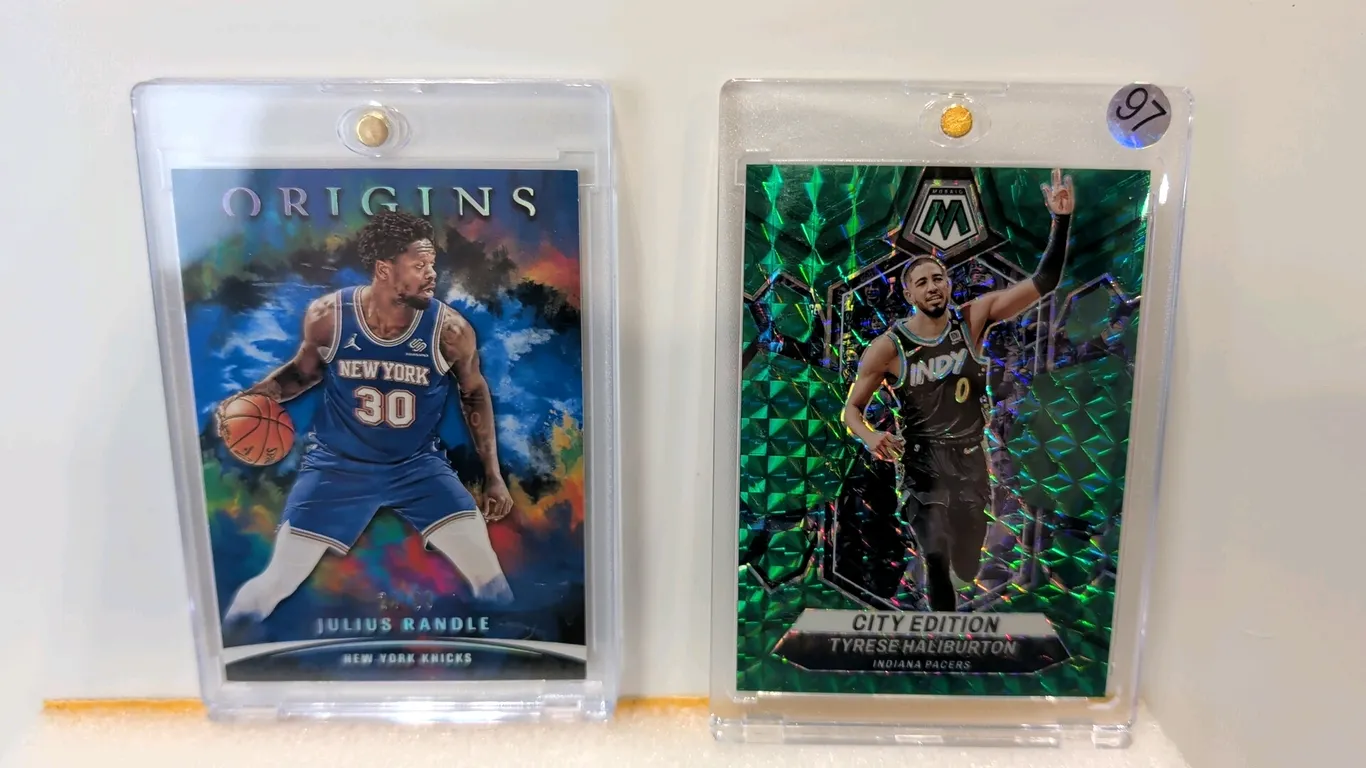 A Pair of Panini NBA Serial-Numbered Trading Cards. (Panini, 2021-2024) Includes a 2021-22 Panini Origins Julius Randle #33 (numbered 24/99) and a 202