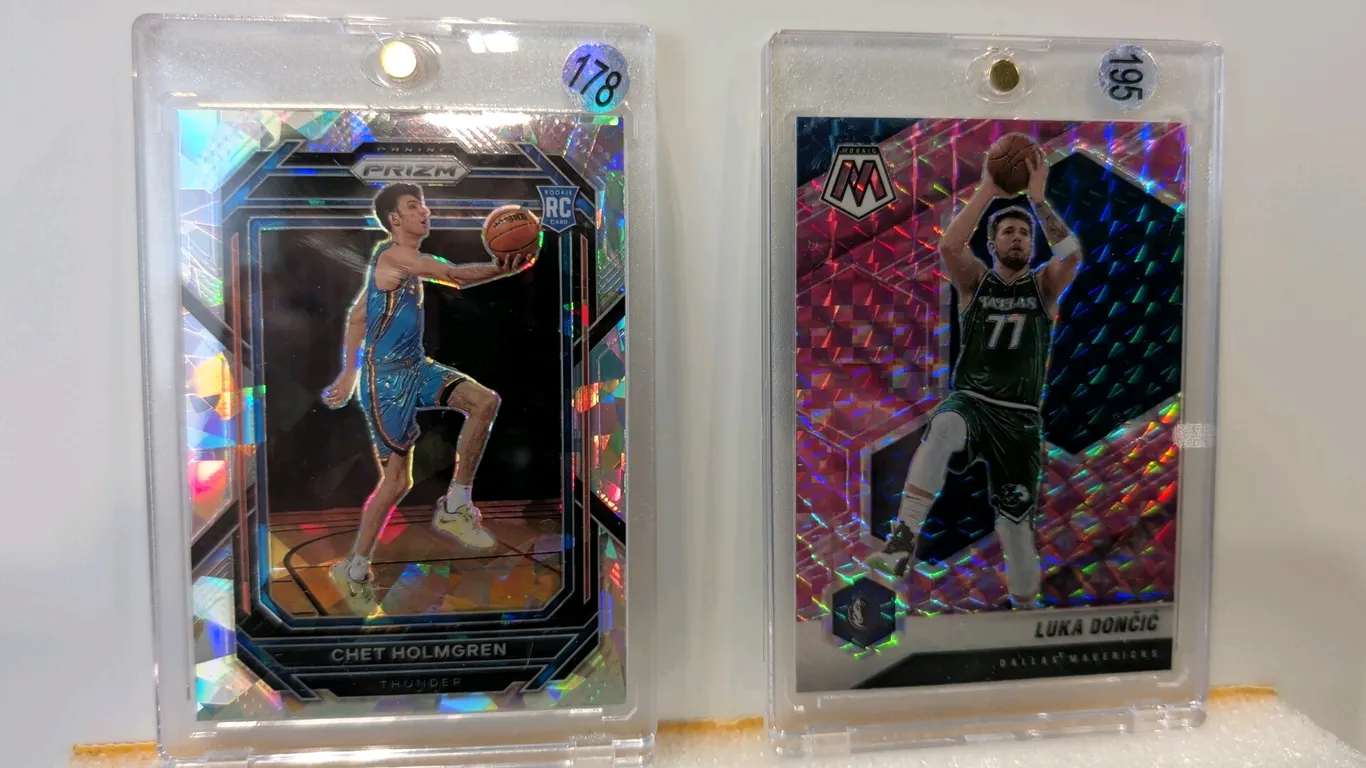 A Pair of Panini Basketball Trading Cards. (Panini, 2020-2023) Includes a 2022-23 Panini Prizm Chet Holmgren Rookie Card No. 266 cracked ice parallel