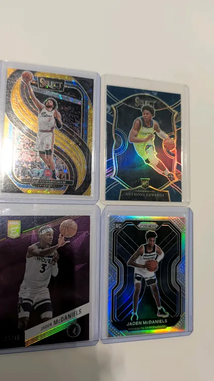 A Collection of Four Panini Basketball Cards. (Panini, 2020-2025) Includes 2024-25 Select Cade Cunningham Gold Flash Prizm 02/10 (No. 164), 2020-21 Se