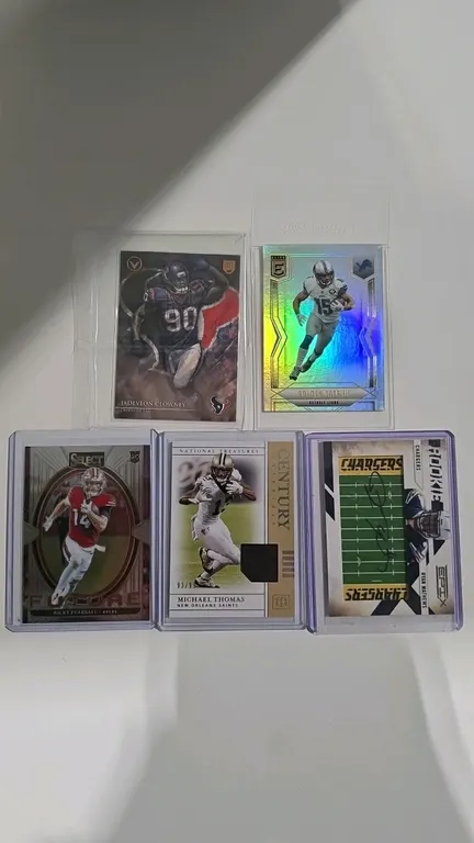 A Collection of NFL Trading Cards. (Panini/Topps, 2010-2025) A 5-piece card lot featuring a 2024 Panini Select Ricky Pearsall RC, 2019 Panini Michael