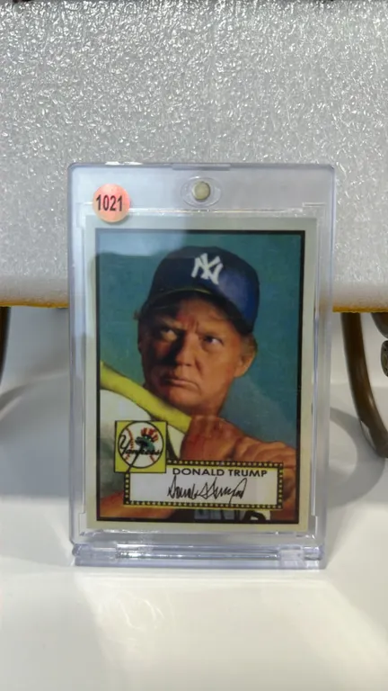 A Donald Trump New York Yankees Novelty Baseball Card. Styled in the classic 1952 Topps design, featuring Donald Trump in a Yankees uniform holding a