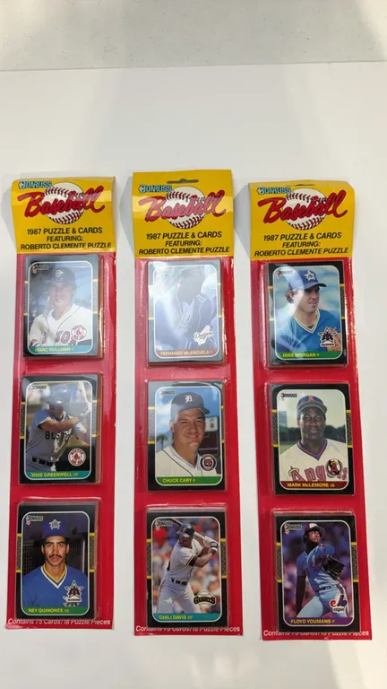 A Set of 1987 Donruss Baseball Rack Packs. (Leaf, Inc., 1987) Three unopened rack packs, each containing 75 cards and 18 Roberto Clemente puzzle piece