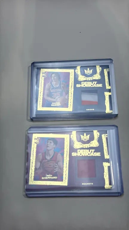 A Pair of 2024-25 Panini Court Kings Debut Showcase Rookie Cards. (Panini, 2024-25) Includes Pacôme Dadiet (No. DSM-PCM) and Reed Sheppard (No. DSM-RD