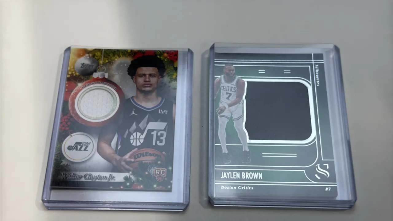 A Pair of NBA Relic Trading Cards. (Panini/Topps, 2024-2025) Includes a 2024-25 Panini Silhouette Jaylen Brown game-worn jersey card (No. S-JBW) with
