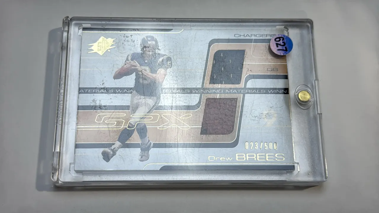 An Upper Deck SPx "Winning Materials" Drew Brees Dual-Relic Trading Card. (Upper Deck, 2001) A San Diego Chargers rookie card, No. WM-DB, numbered 023