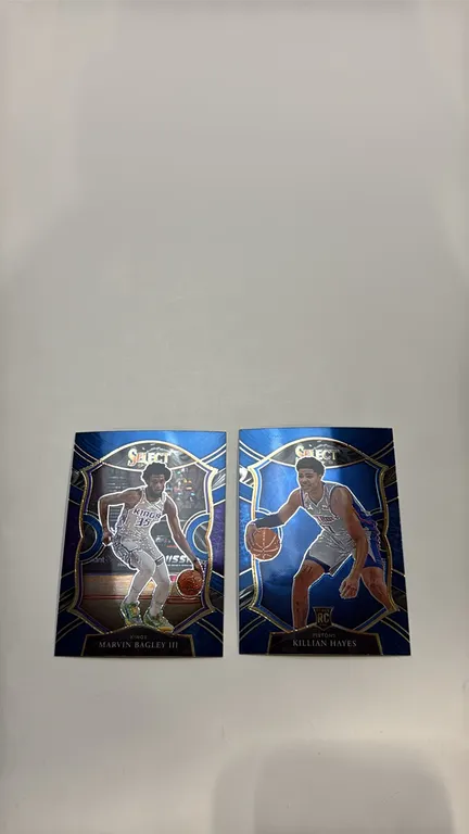 A Pair of 2020-21 Panini Select Basketball Cards. (Panini, 2021) Includes Marvin Bagley III (Sacramento Kings, No. 25) and a Killian Hayes Rookie Card