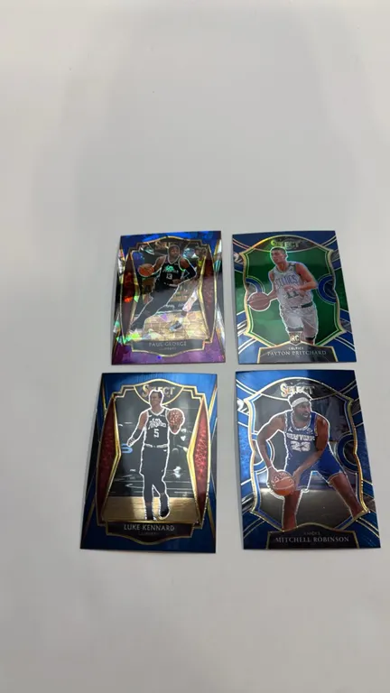 A Collection of 2020-21 Panini Select Basketball Cards. (Panini, 2020-21) A 4-card lot including Paul George (No. 156 Premier Level), Payton Pritchard