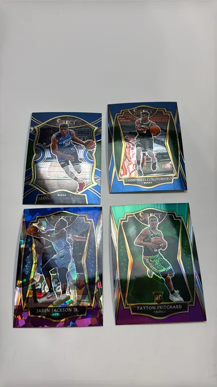 A Collection of 2020-21 Panini Select Basketball Cards. (Panini, 2020-21) A 4-card lot including (2) Giannis Antetokounmpo (No. 54 Concourse, No. 117