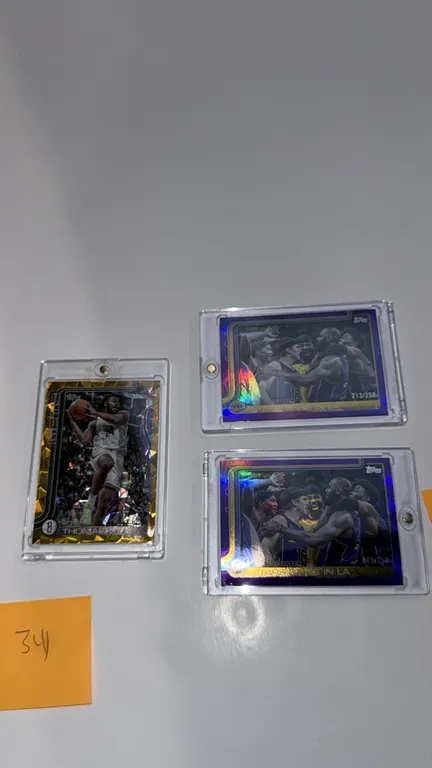 A Collection of 2025 Topps Flagship X Basketball Cards. (Topps, 2025) Includes (1) Cam Thomas Brooklyn Nets #11 gold parallel numbered 43/50 and (2) L