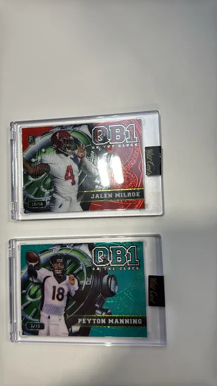 A Pair of Wild Card QB1 "On the Clock" Encased Football Cards. (Wild Card, 2024) Includes a Peyton Manning teal parallel numbered 1/15 (OCW-TL-PM1) an
