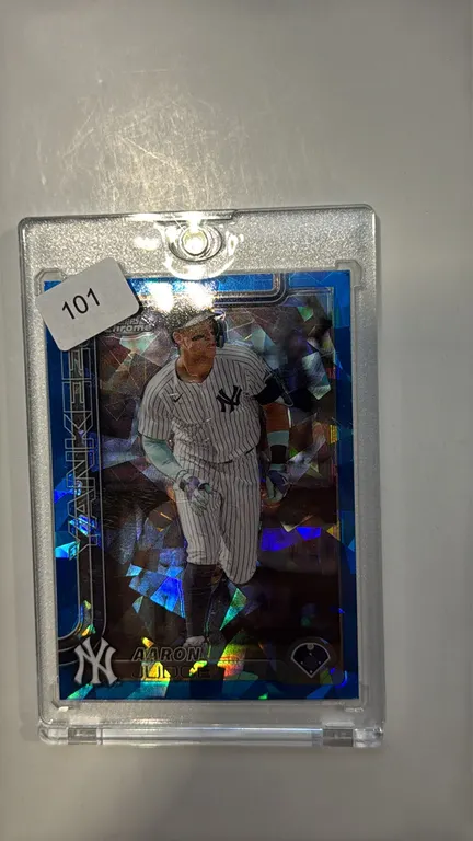 An Aaron Judge 2025 Topps Chrome #99 Baseball Trading Card. (Topps, 2025) A Topps Chrome trading card featuring New York Yankees outfielder Aaron Judg