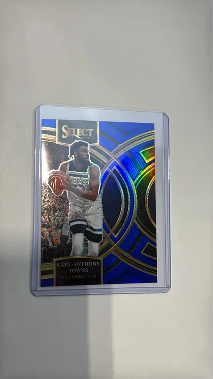 A 2023-24 Panini Select Karl-Anthony Towns Trading Card. (Panini, 2023-24) A Premier Level Prizm basketball card No. 196 featuring Karl-Anthony Towns