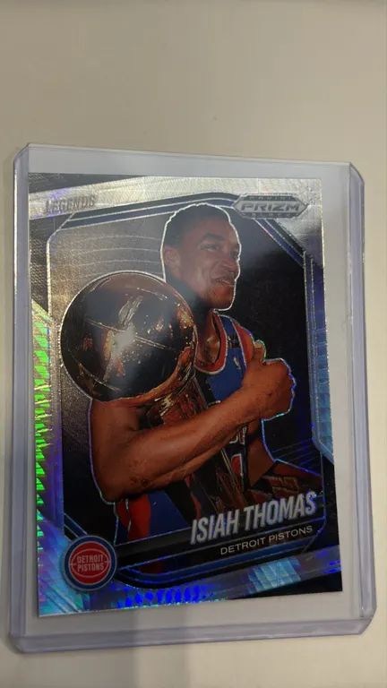 An Isiah Thomas 2024-25 Panini Prizm Black Basketball Trading Card. (Panini, 2024-25) A Panini Prizm Black Legends trading card featuring Detroit Pist